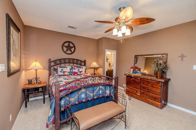 carpeted bedroom with baseboards, visible vents, and ceiling fan