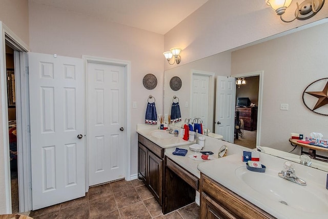 bathroom with baseboards and vanity
