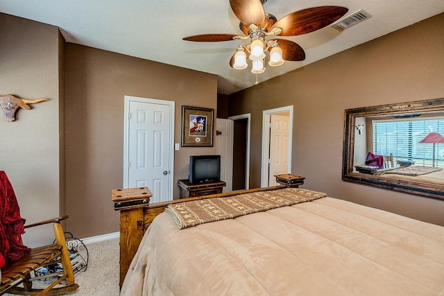 bedroom with carpet, visible vents, a ceiling fan, and baseboards