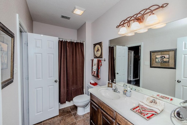 bathroom with visible vents, toilet, curtained shower, and vanity