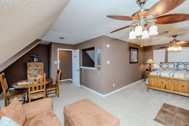 carpeted bedroom with a textured ceiling, visible vents, ceiling fan, and baseboards