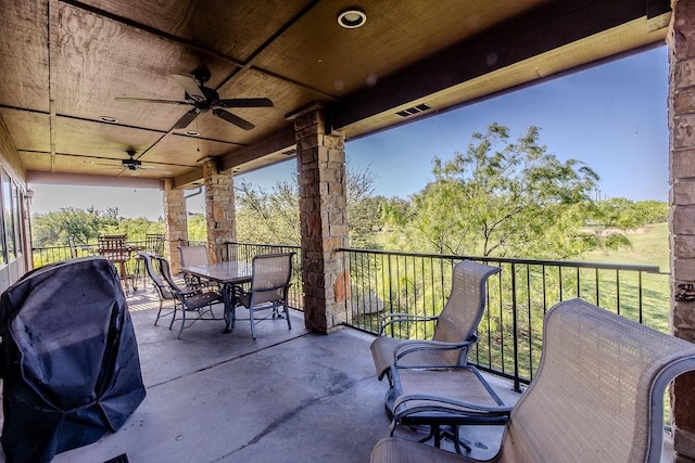 view of patio featuring ceiling fan, area for grilling, and outdoor dining area