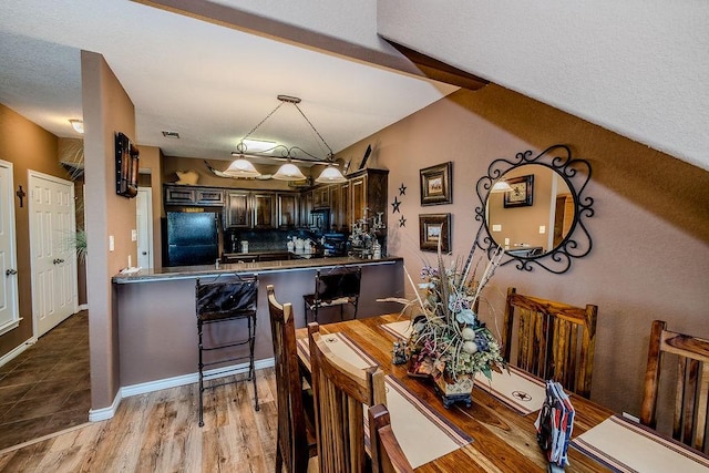 dining room with wood finished floors and baseboards