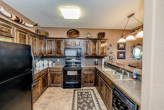 kitchen featuring tasteful backsplash, a sink, dark brown cabinetry, black appliances, and light tile patterned flooring