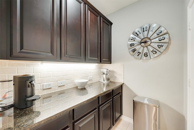 3808 Jeanette Ln, Mckinney, TX 75071 - kitchen with dark brown cabinets, stone counters, tasteful backsplash, and light tile patterned flooring