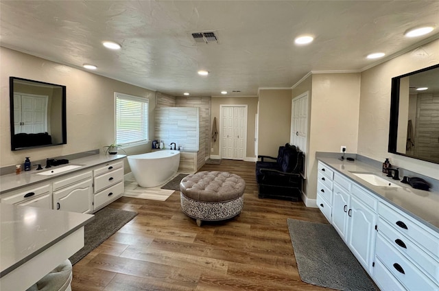 712 State Highway 67, Graham, TX 76450 - bathroom featuring recessed lighting, a sink, a freestanding bath, and visible vents