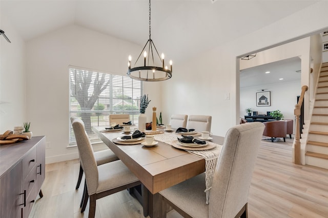dining room with lofted ceiling, light wood-style floors, recessed lighting, a notable chandelier, and stairs