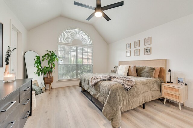 bedroom with light wood-type flooring, a ceiling fan, and lofted ceiling