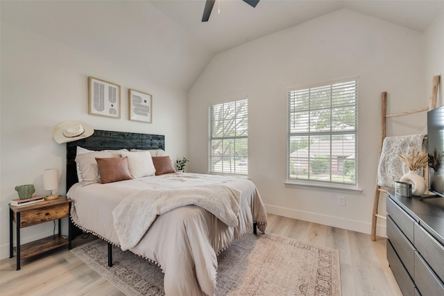 bedroom with baseboards, light wood-style flooring, a ceiling fan, and lofted ceiling