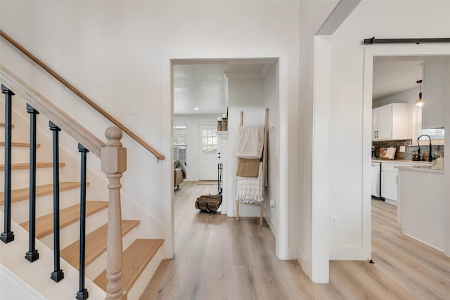 staircase with wood finished floors and baseboards