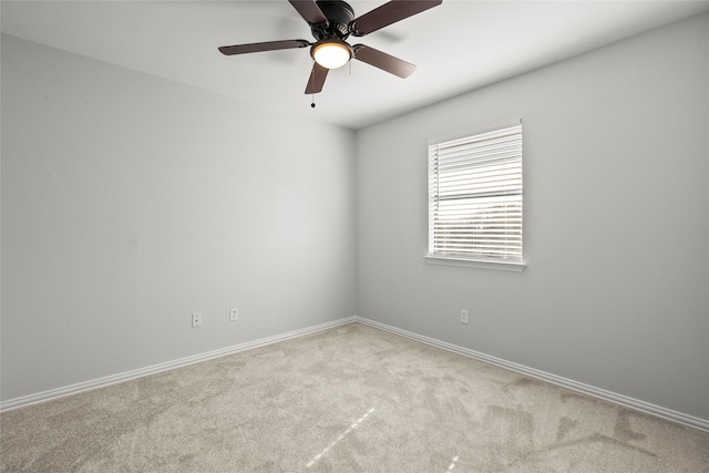 carpeted empty room with baseboards and ceiling fan