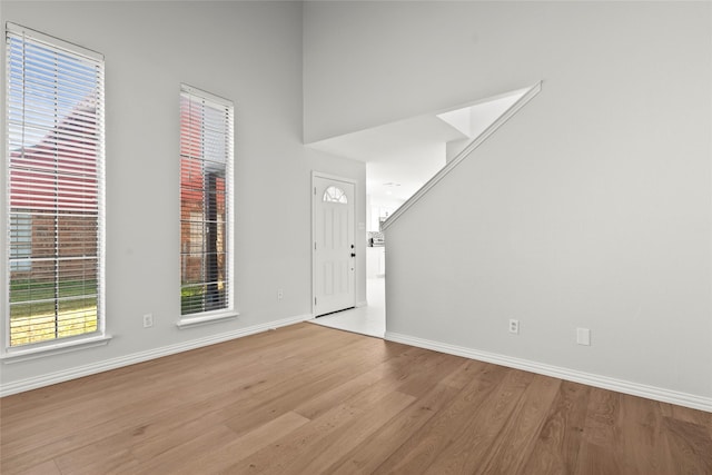 entryway with baseboards and wood finished floors
