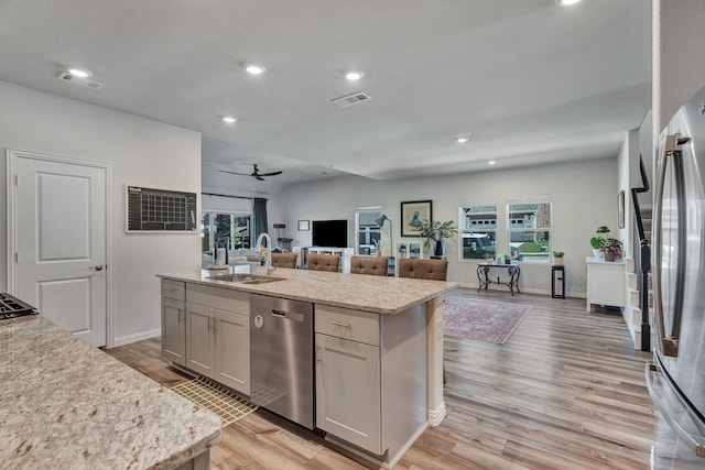 1409 Kirkdale Dr, Melissa, TX 75454 - kitchen featuring visible vents, light wood-style floors, open floor plan, a sink, and stainless steel appliances
