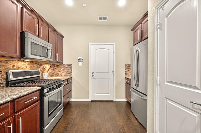kitchen with decorative backsplash, appliances with stainless steel finishes, dark wood-style flooring, baseboards, and visible vents