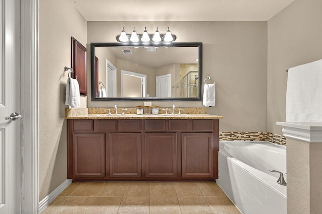 full bath with a garden tub, double vanity, a sink, and tile patterned floors