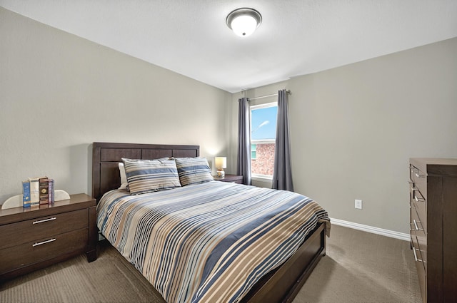 bedroom featuring carpet floors and baseboards