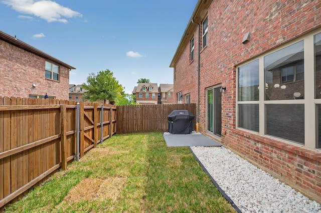 view of yard with a patio and a fenced backyard