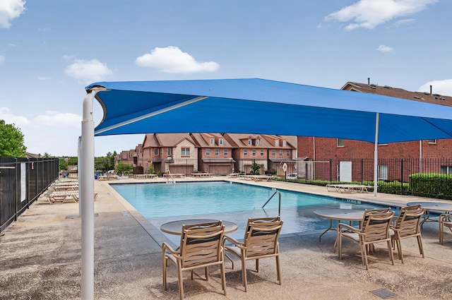 pool featuring a patio and fence