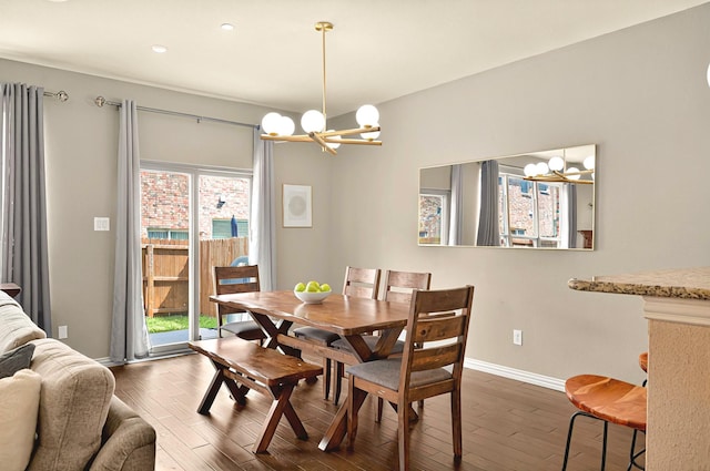 dining space featuring an inviting chandelier, recessed lighting, dark wood-style floors, and baseboards