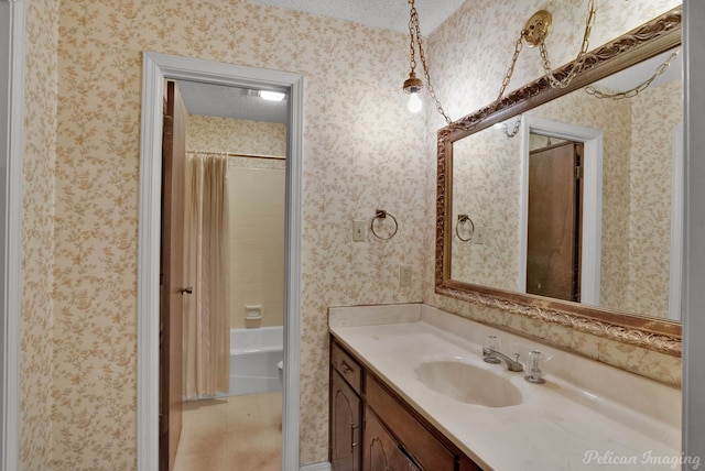 bathroom with vanity, shower / bath combination with curtain, and wallpapered walls
