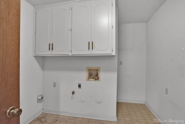 laundry area with light floors, electric dryer hookup, cabinet space, washer hookup, and a textured ceiling