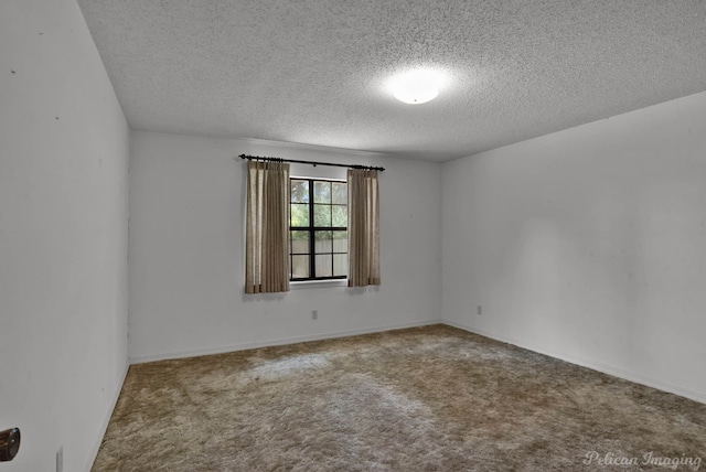 unfurnished room featuring a textured ceiling and carpet flooring