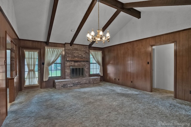 unfurnished living room with vaulted ceiling with beams, a notable chandelier, wooden walls, and carpet flooring
