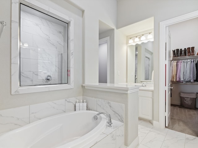 14840 Gentry Dr, Aledo, TX 76008 - bathroom with marble finish flooring, a garden tub, vanity, and a spacious closet