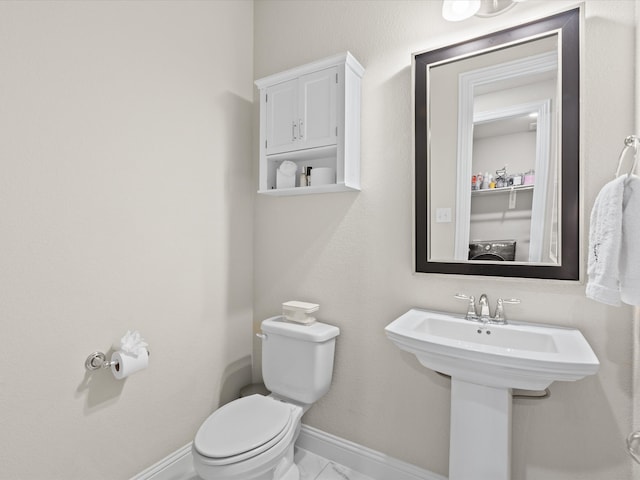 14840 Gentry Dr, Aledo, TX 76008 - half bathroom with toilet, marble look tile flooring, and baseboards
