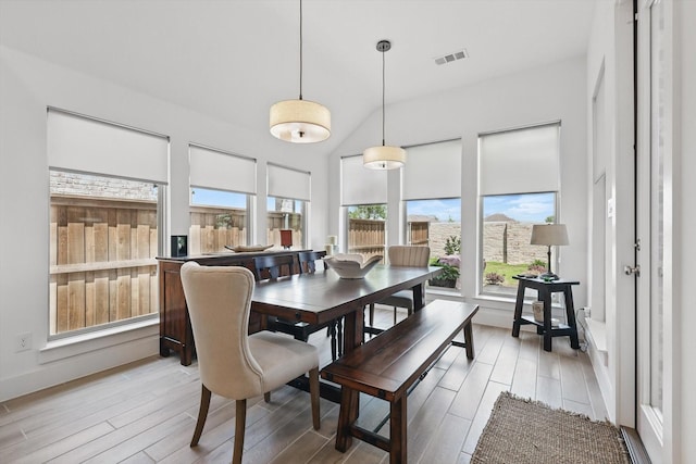 dining space featuring visible vents, light wood finished floors, and baseboards