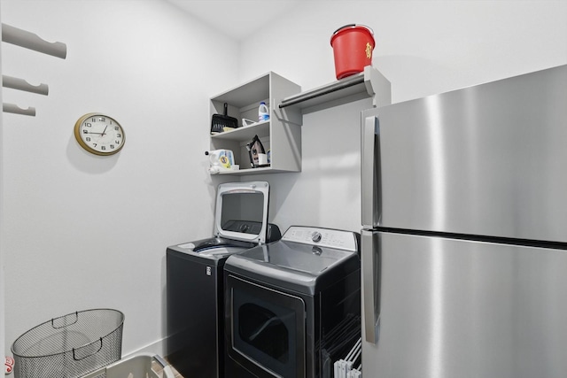clothes washing area featuring independent washer and dryer and laundry area