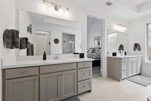 full bathroom featuring ensuite bath, a walk in shower, two vanities, a sink, and visible vents