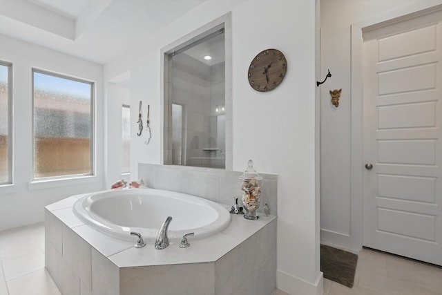 bathroom featuring tile patterned floors, a tile shower, and a bath