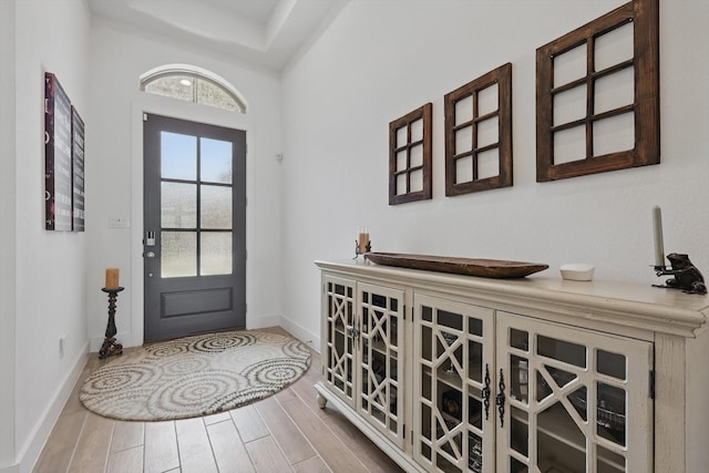 entryway featuring wood finished floors and baseboards