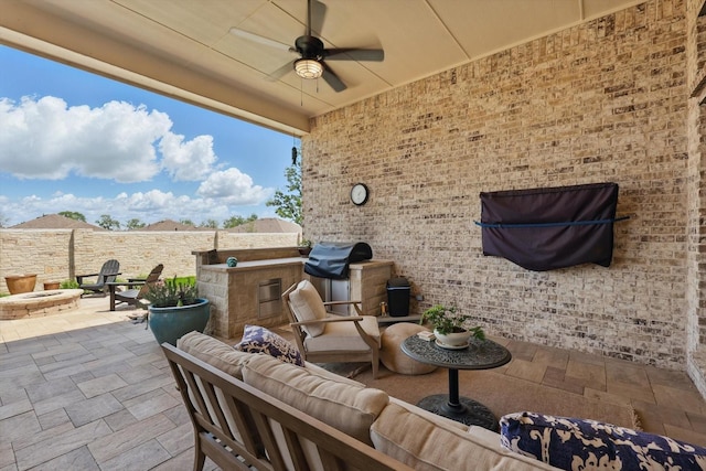 view of patio / terrace with an outdoor living space with a fire pit, ceiling fan, a fenced backyard, and grilling area