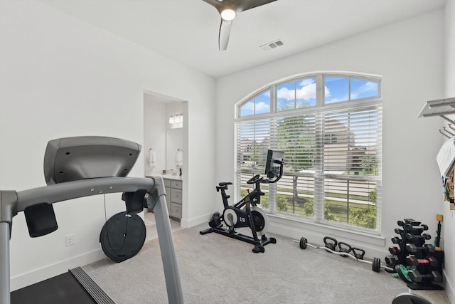 workout room with visible vents, a ceiling fan, carpet flooring, and baseboards
