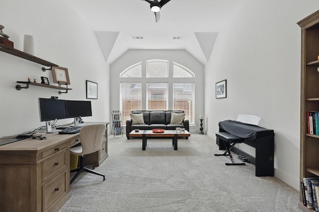 office space featuring visible vents, vaulted ceiling, light colored carpet, and baseboards