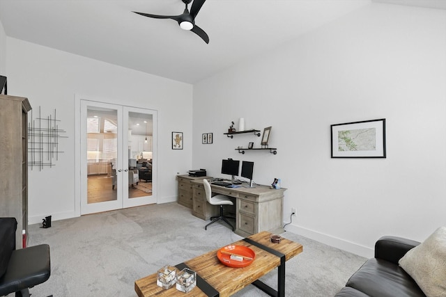 office area with french doors, a ceiling fan, baseboards, and light carpet