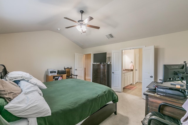 bedroom with connected bathroom, visible vents, vaulted ceiling, light carpet, and a ceiling fan