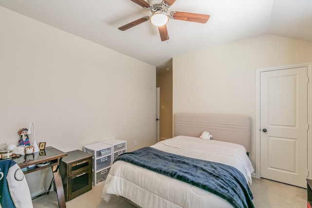 bedroom with lofted ceiling, light colored carpet, and a ceiling fan