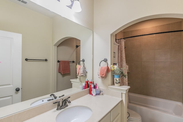 bathroom with shower / tub combo, toilet, and vanity