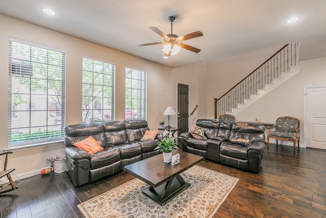 living area with a healthy amount of sunlight, a ceiling fan, and dark wood finished floors