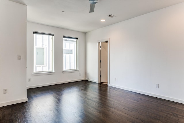 unfurnished room with dark wood finished floors, recessed lighting, ceiling fan, baseboards, and visible vents