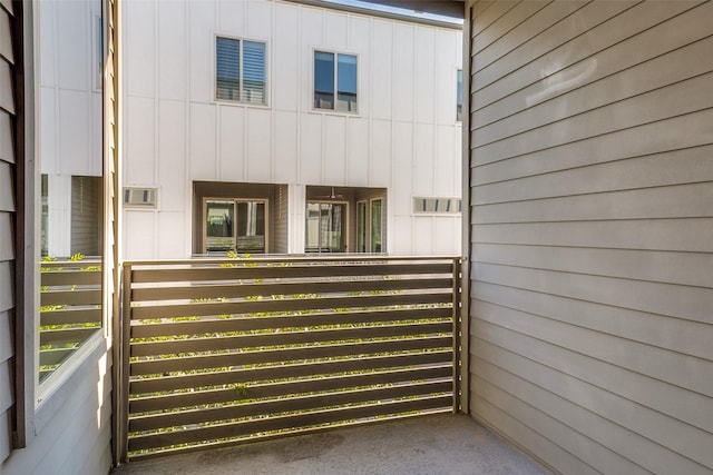 exterior space with board and batten siding and a balcony