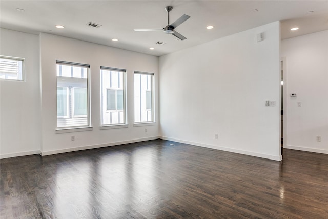 empty room with dark wood-type flooring, visible vents, a ceiling fan, and recessed lighting