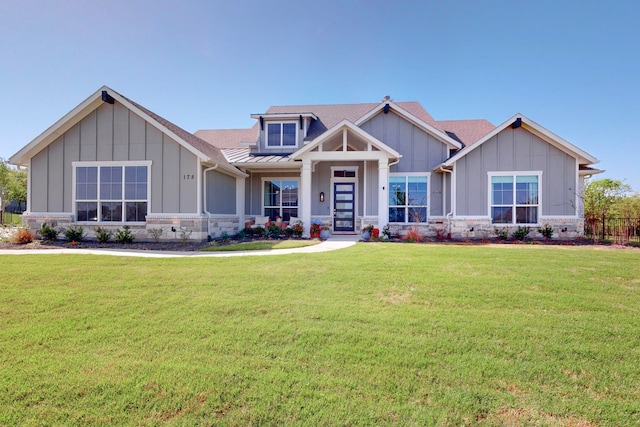 craftsman-style house with board and batten siding and a front lawn