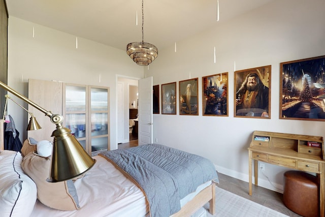 bedroom featuring baseboards and wood finished floors