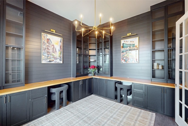 interior space featuring built in study area, wooden walls, and light carpet