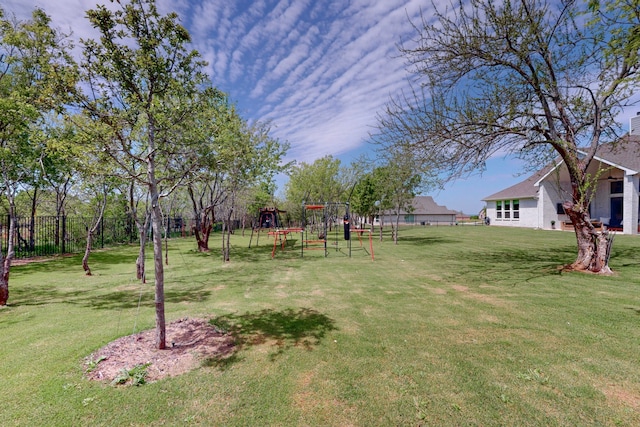 view of yard with a playground and fence