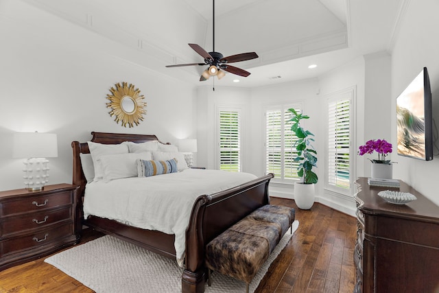 bedroom featuring dark wood finished floors, baseboards, ceiling fan, and crown molding
